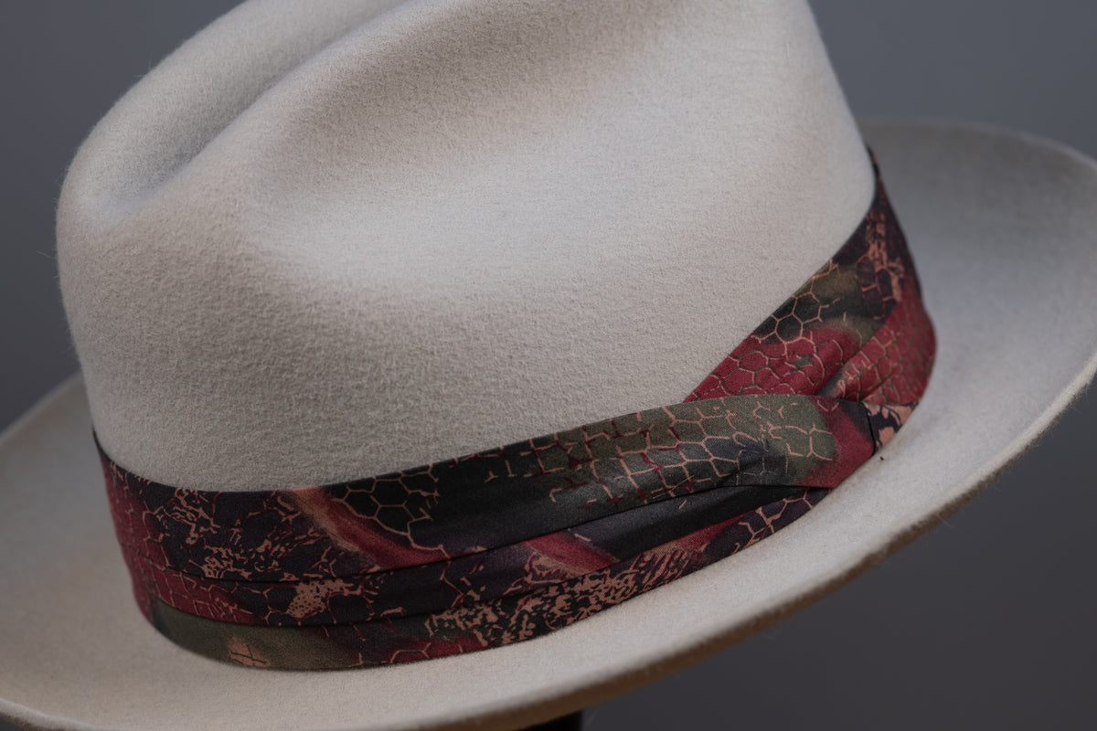 A hatband with a floral pattern on a white background, designed to be attached to a hat.