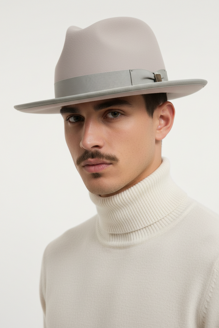 Man wearing a Bone Rabbit Fur Fedora and white turtleneck sweater against a light background