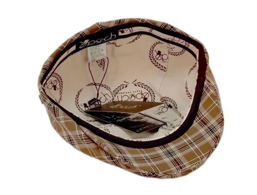 A vintage-style flat cap shown from an overhead angle, featuring a tan and brown plaid pattern on the exterior and a cream-colored interior printed with a bicycle motif and the brand name 'Brixwood'.