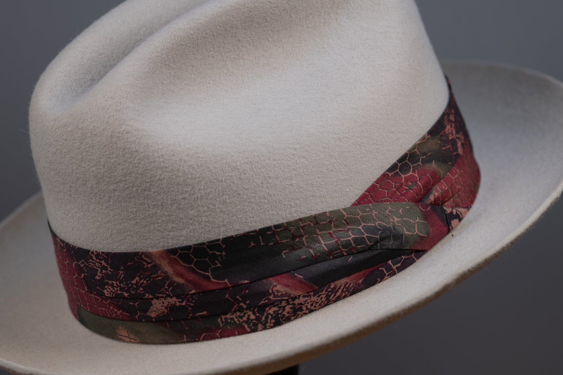 A hatband with a floral pattern on a white background, designed to be attached to a hat.