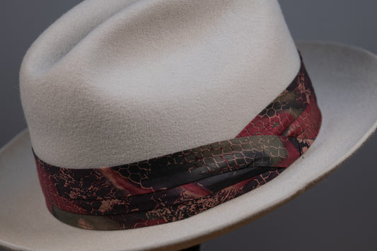 A hatband with a floral pattern on a white background, designed to be attached to a hat.