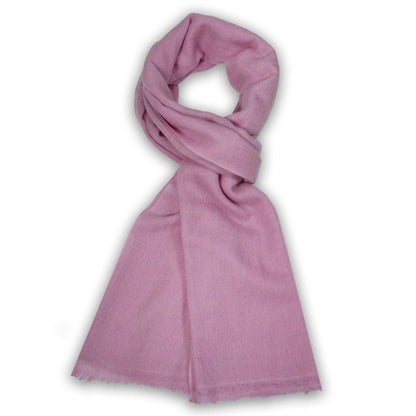 A dusty pink scarf with a soft, lightweight texture and fringed edges, styled in a loop on a white background.