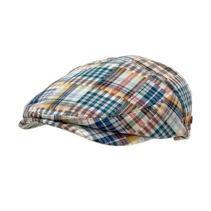 A vintage-style flat cap with a multicolor plaid pattern featuring blue, green, yellow, orange, and red lines on a light background, shown against a plain white background.